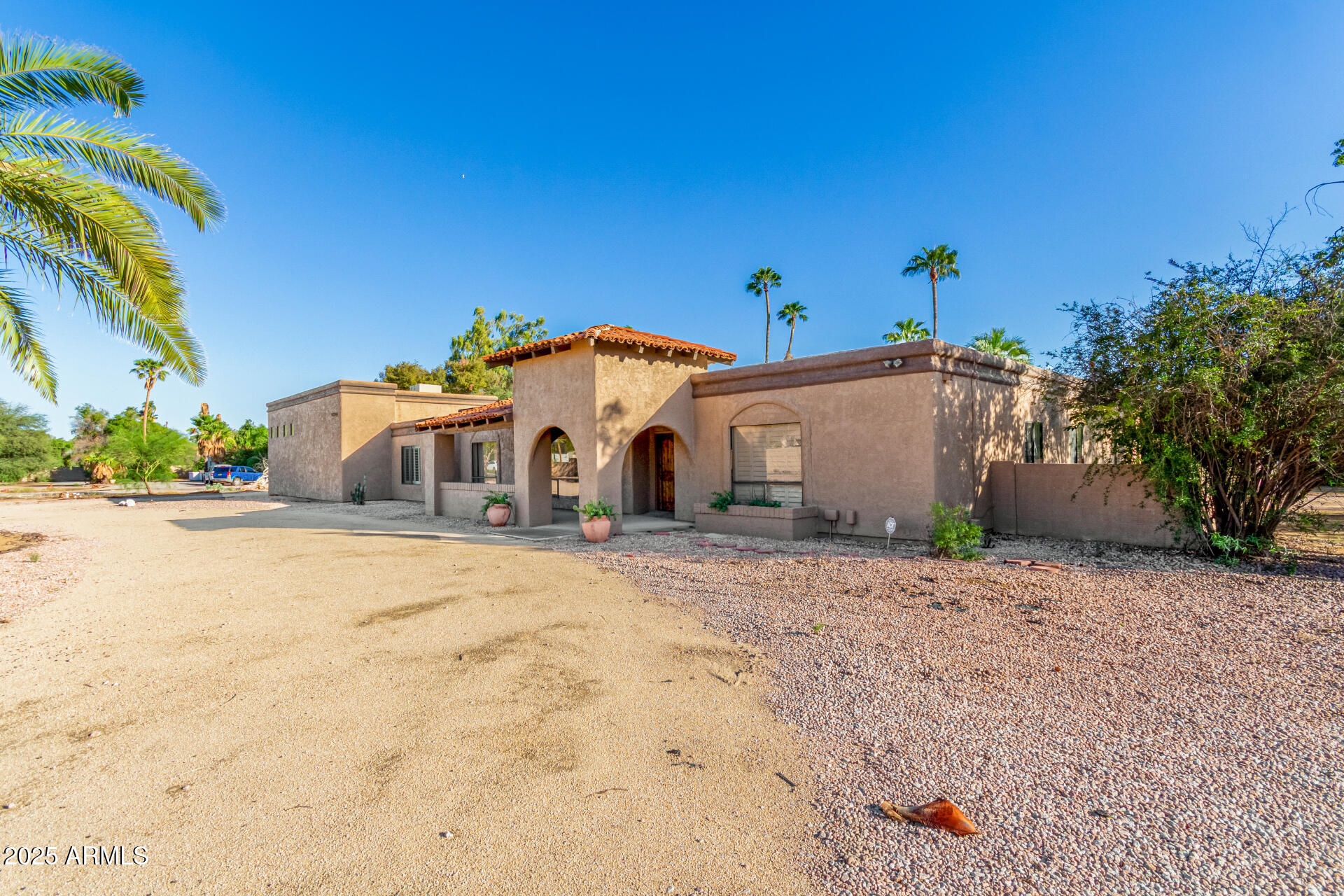 5739 East Cactus Road Scottsdale, AZ 85254 - Photo 4 of 52 a front view of a house with a yard and garage