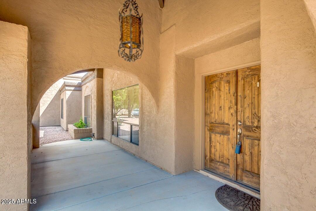 5739 East Cactus Road Scottsdale, AZ 85254 - Photo 50 of 52 a bedroom with a bed and a mirror