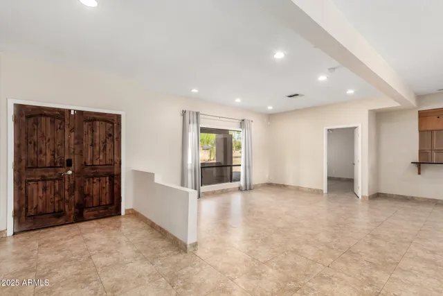 an empty room with closet and windows