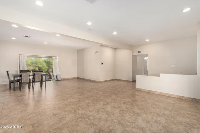 a view of dining room with furniture and floor to ceiling window