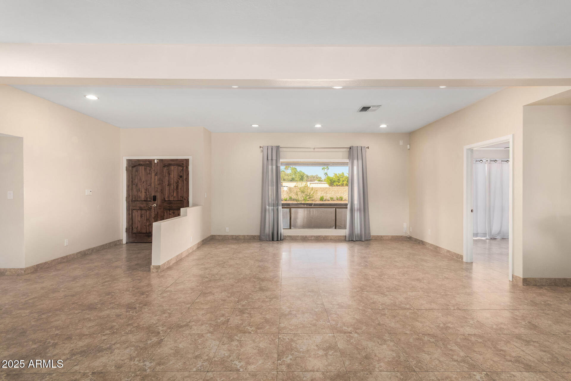 5739 East Cactus Road Scottsdale, AZ 85254 - Photo 8 of 52 an empty room with a window and a kitchen