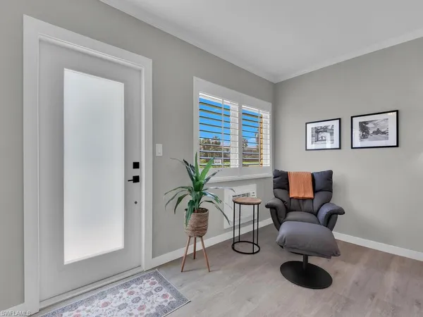 a living room with furniture potted plant and a window