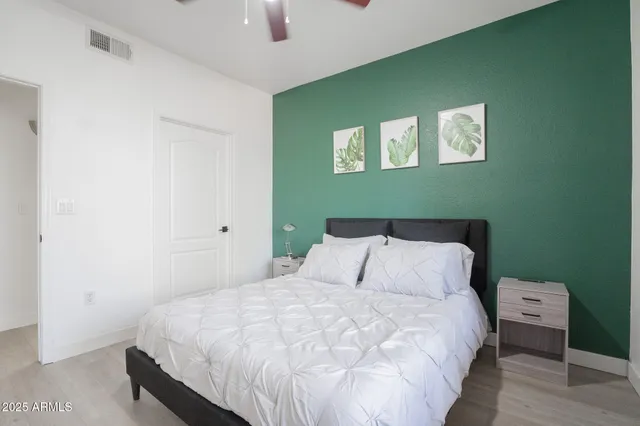 a bedroom with a bed and a chandelier