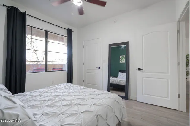 a bedroom with a bed and a window