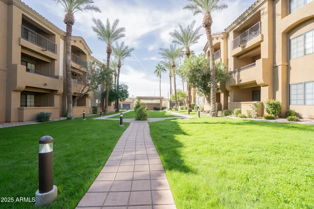a front view of a building with a garden