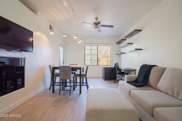 a living room with furniture a flat screen tv and a fireplace