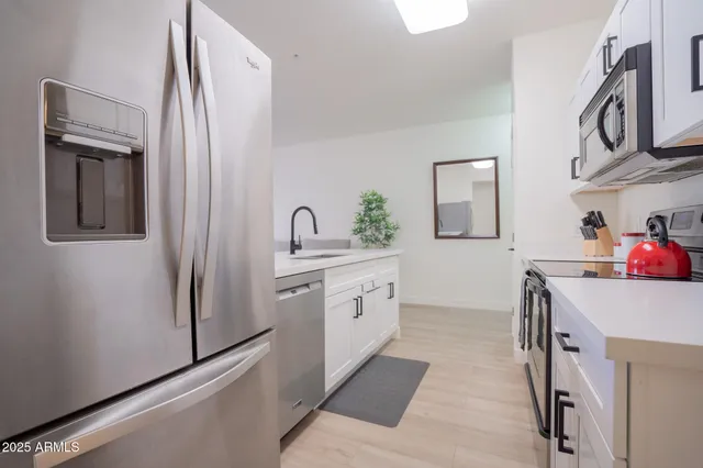 a kitchen with cabinets and stainless steel appliances