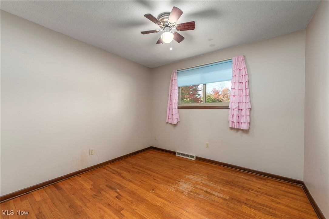 7717 Hoertz Road Cleveland, OH 44134 - Photo 20 of 49 Spare room with light hardwood / wood-style flooring, a textured ceiling, and ceiling fan