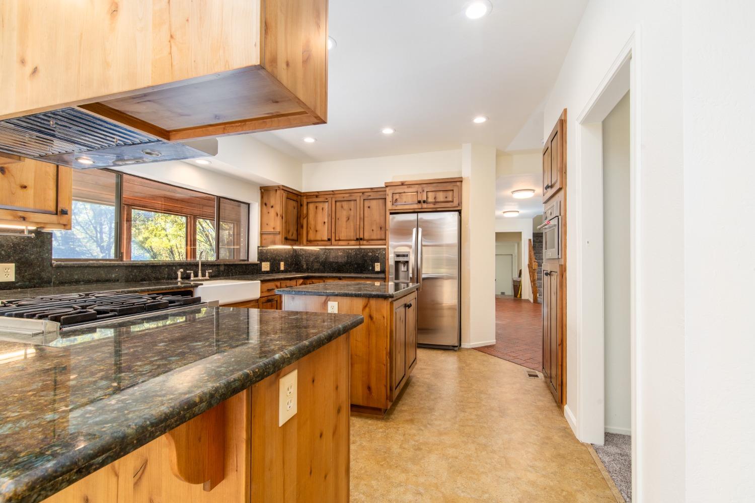 3961 7 Ridges Road Camino, CA 95709 - Photo 28 of 86 a kitchen with stainless steel appliances granite countertop a refrigerator a sink and a stove