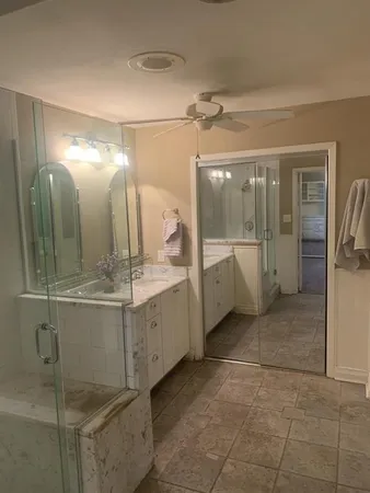 a bathroom with a mirror and a shower
