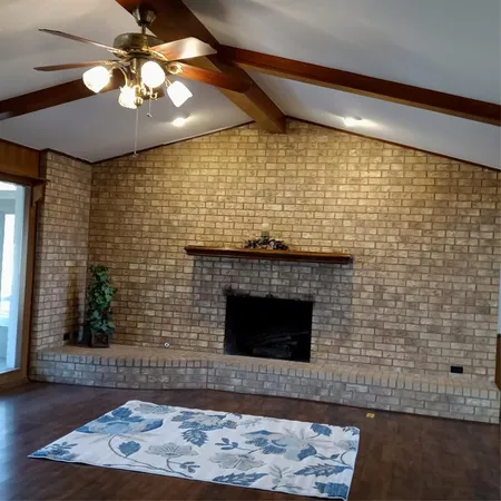 a room with a wooden floor and a fireplace