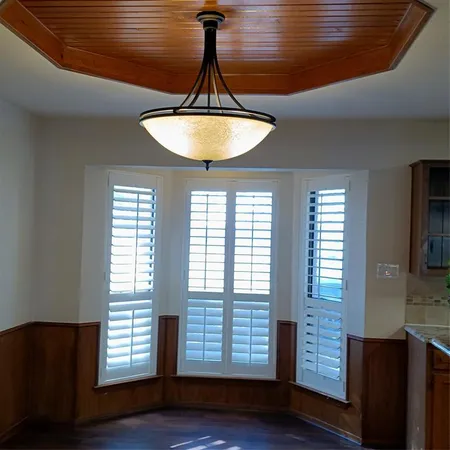 a room with wooden floor and chandelier