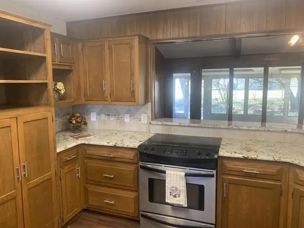 a kitchen with granite countertop cabinets stainless steel appliances and a sink