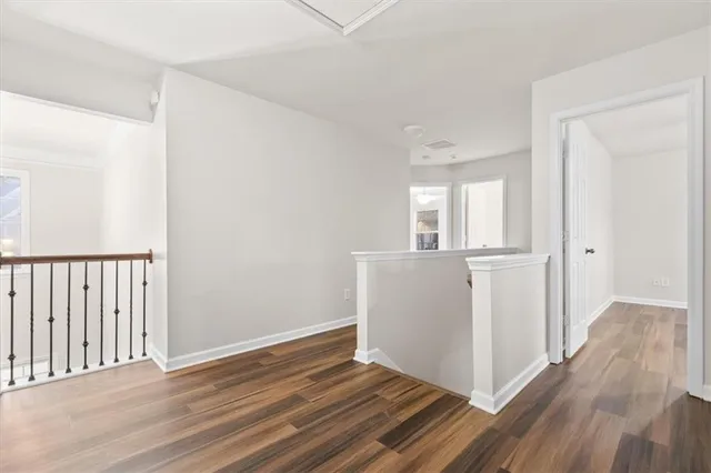 a view of a room with wooden floor