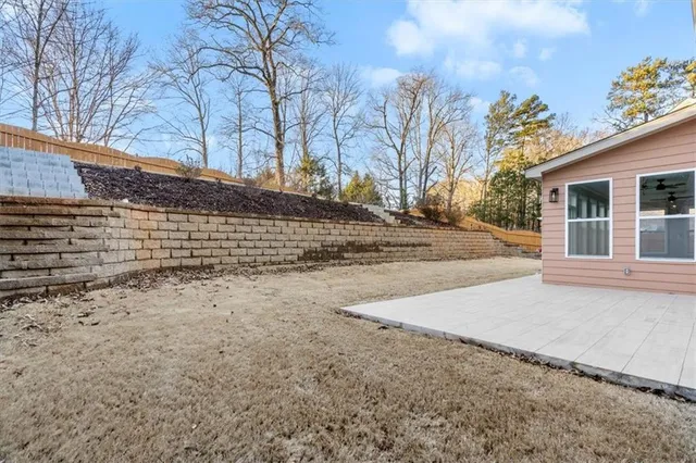 a view of a yard with a house and a trees