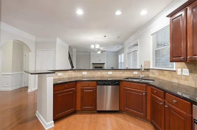 a kitchen with a sink a stove and cabinets