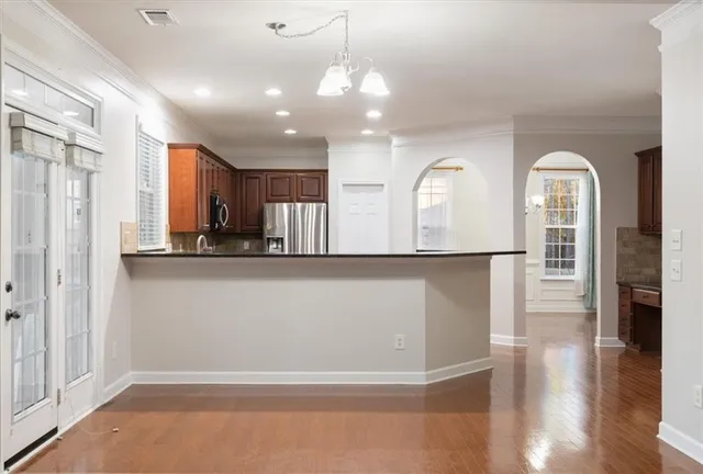 a view of entryway with kitchen and hallway