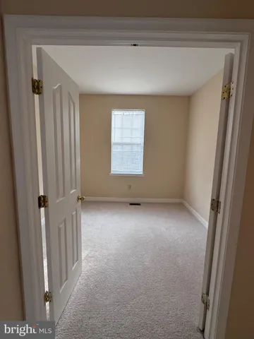 a view of hallway with wooden floor