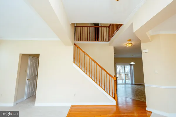 a view of a hallway with entryway wooden floor and front door
