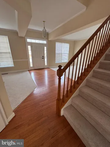 a view of entryway and hall with wooden floor
