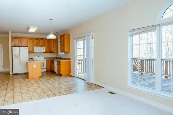a kitchen with a refrigerator and a stove top oven