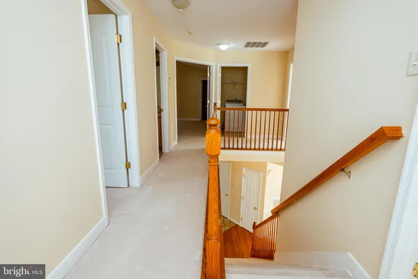 a view of a hallway with staircase
