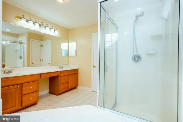 a spacious bathroom with a double vanity sink mirror and double
