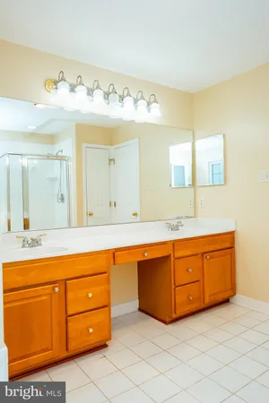 a spacious bathroom with a double vanity sink mirror and bathtub