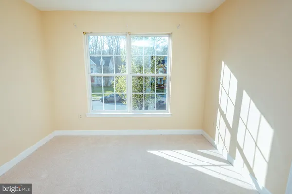 a view of wooden floor and windows in a room