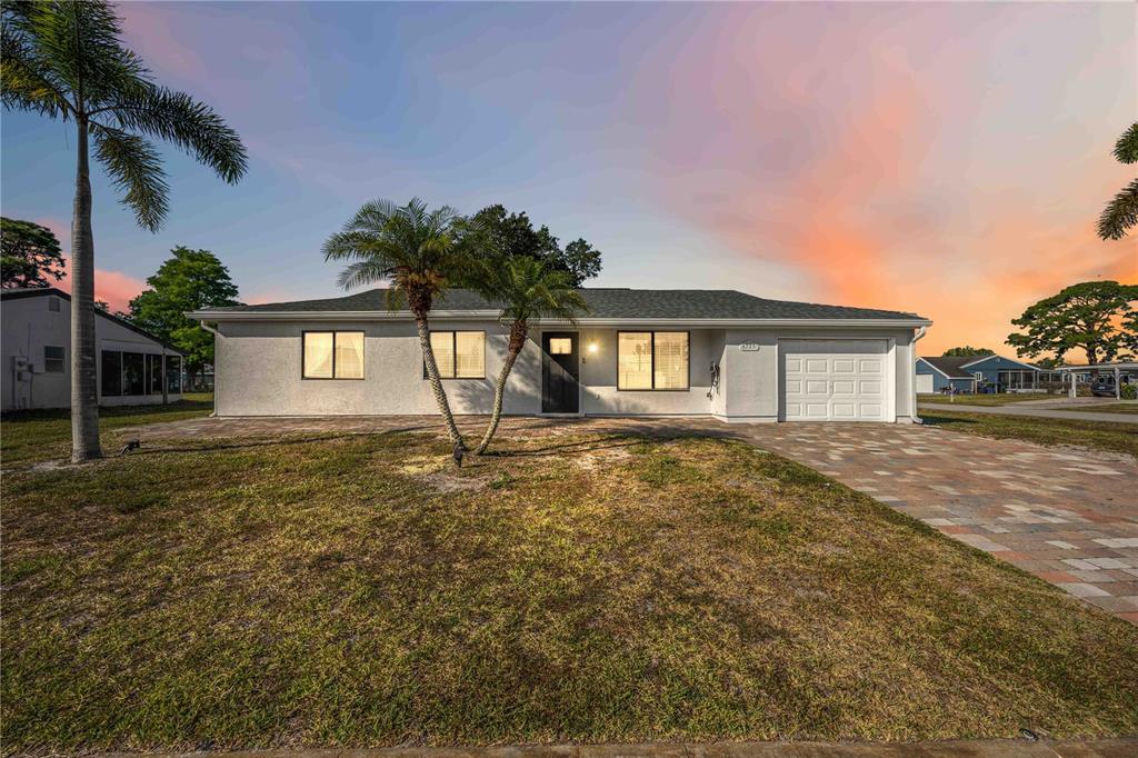 6775 Dennison Avenue North Port, FL 34287 - Photo 1 of 50 a front view of a house with a yard