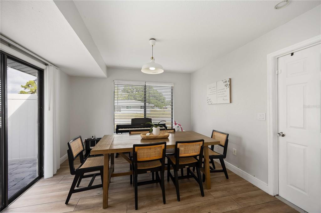 6775 Dennison Avenue North Port, FL 34287 - Photo 13 of 50 a view of a dining room with furniture window and wooden floor