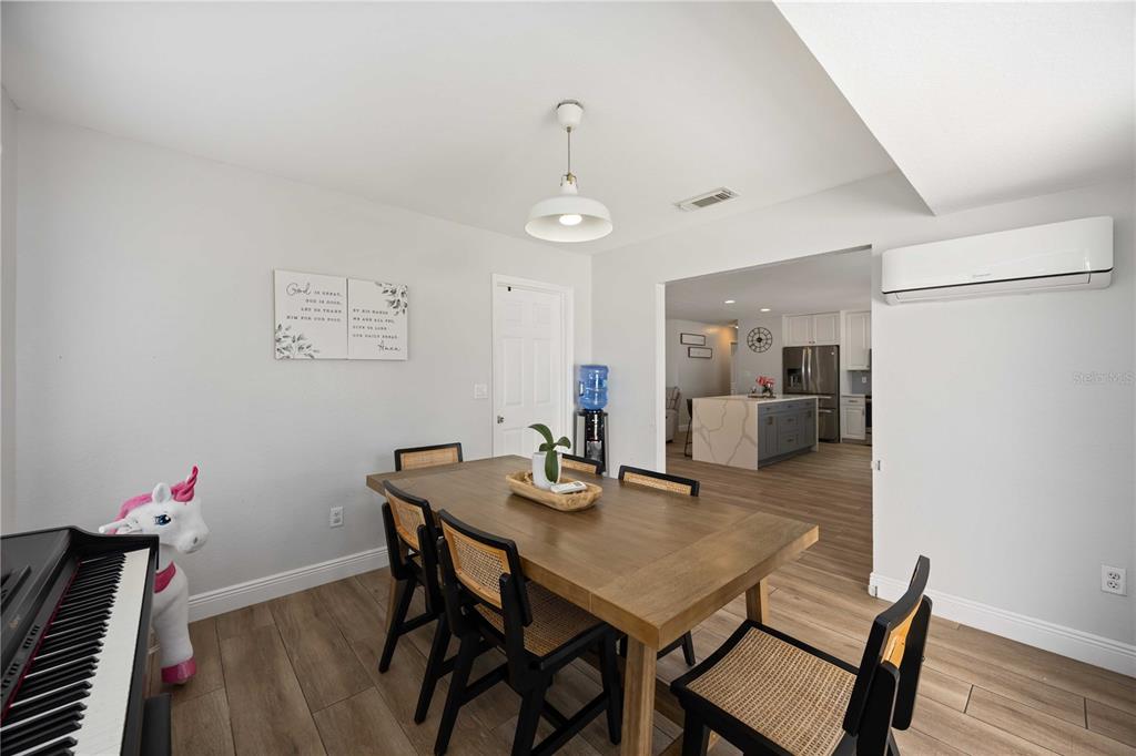 6775 Dennison Avenue North Port, FL 34287 - Photo 15 of 50 a view of a dining room with furniture and wooden floor