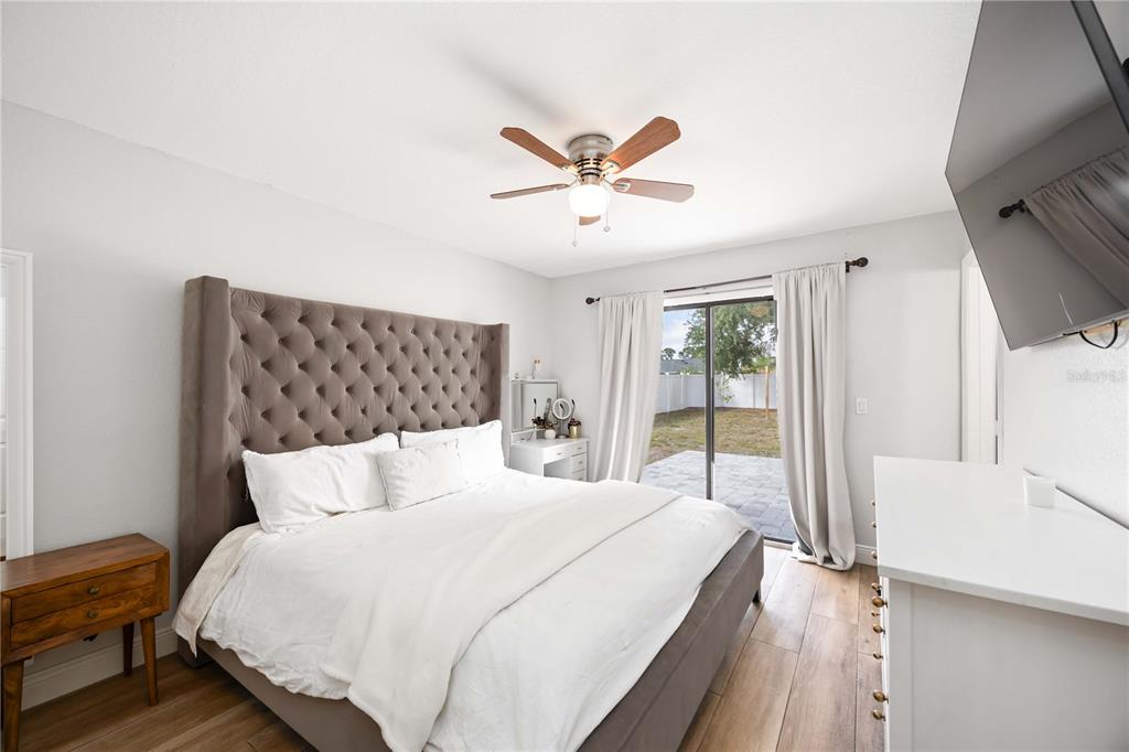 6775 Dennison Avenue North Port, FL 34287 - Photo 23 of 50 a bedroom with a large bed and a chandelier