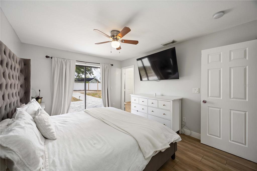 6775 Dennison Avenue North Port, FL 34287 - Photo 24 of 50 a bedroom with a bed a window and a flat screen tv