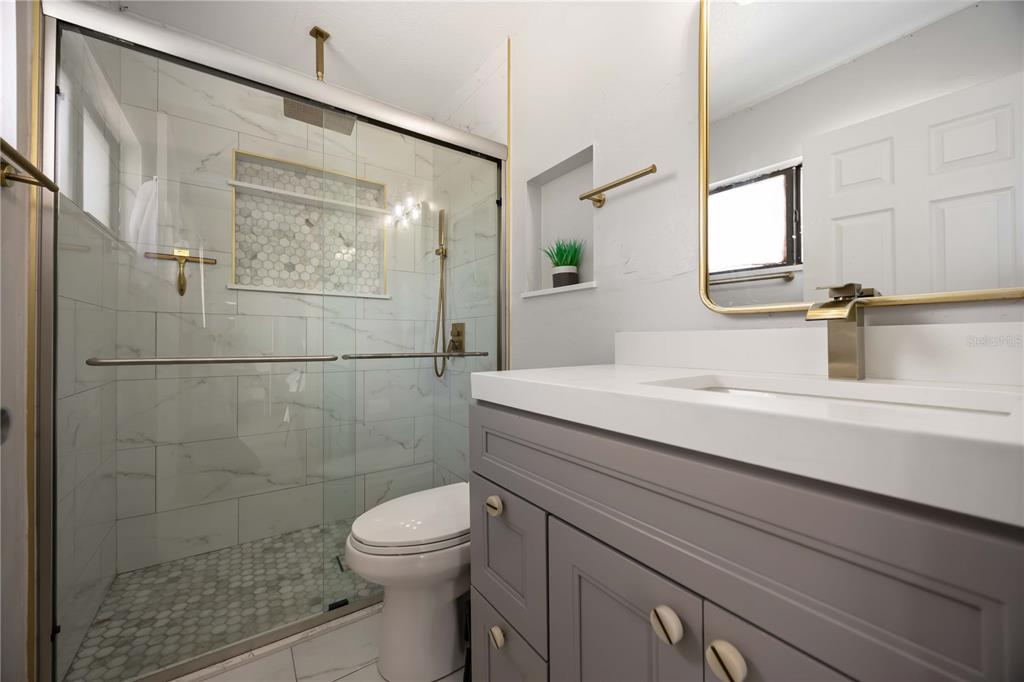 6775 Dennison Avenue North Port, FL 34287 - Photo 27 of 50 a bathroom with a sink a toilet and shower