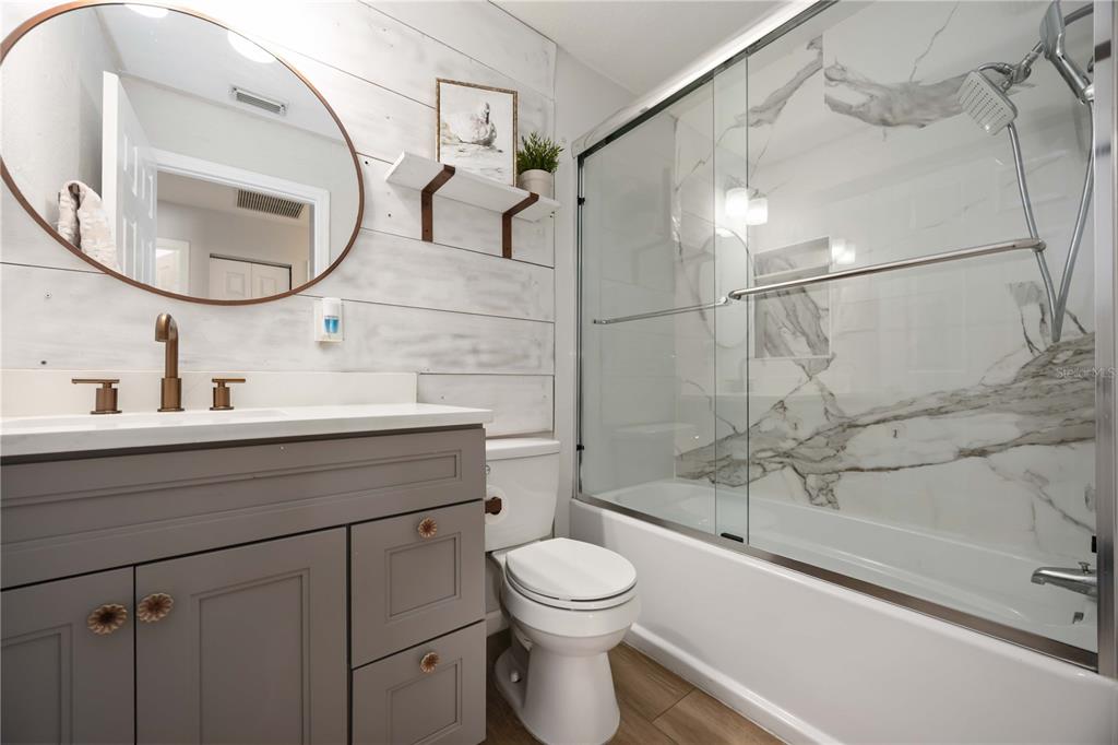 6775 Dennison Avenue North Port, FL 34287 - Photo 28 of 50 a bathroom with a sink a mirror and a toilet