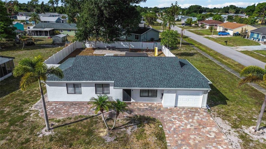 6775 Dennison Avenue North Port, FL 34287 - Photo 38 of 50 a aerial view of a house with a yard and potted plants