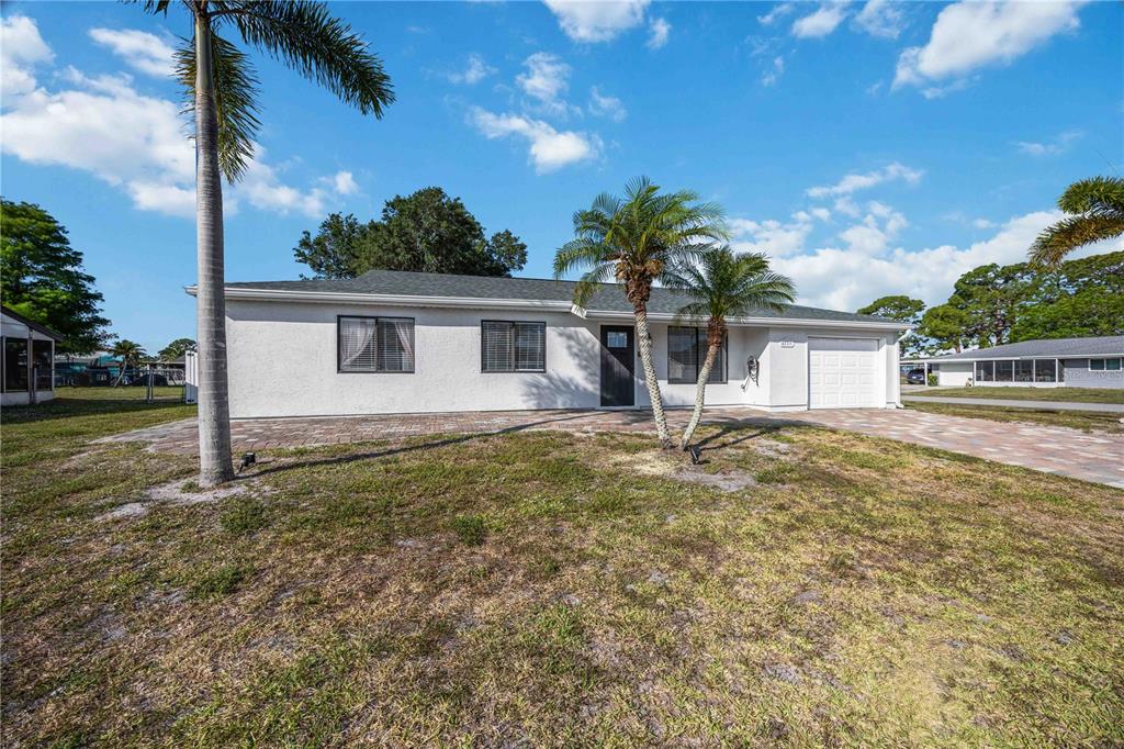 6775 Dennison Avenue North Port, FL 34287 - Photo 44 of 50 a view of a house with backyard and a tree