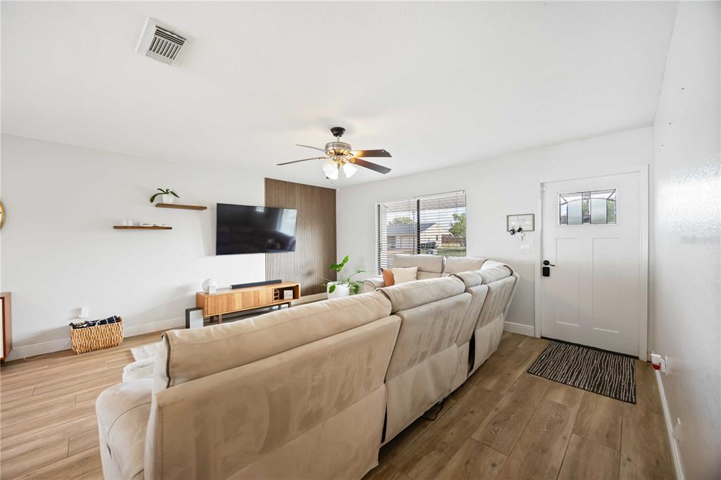 6775 Dennison Avenue North Port, FL 34287 - Photo 5 of 50 a living room with furniture and a flat screen tv