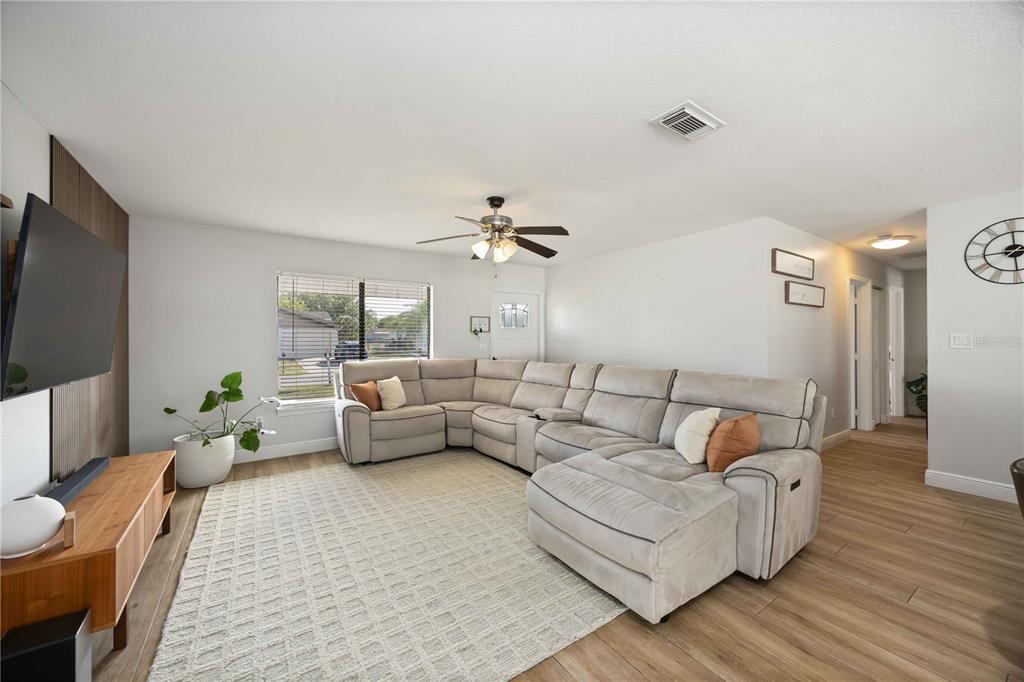 6775 Dennison Avenue North Port, FL 34287 - Photo 7 of 50 a living room with furniture and a flat screen tv
