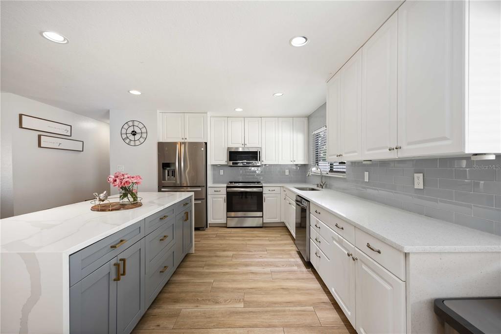 6775 Dennison Avenue North Port, FL 34287 - Photo 9 of 50 a kitchen with kitchen island granite countertop lots of counter top space stainless steel appliances and cabinets