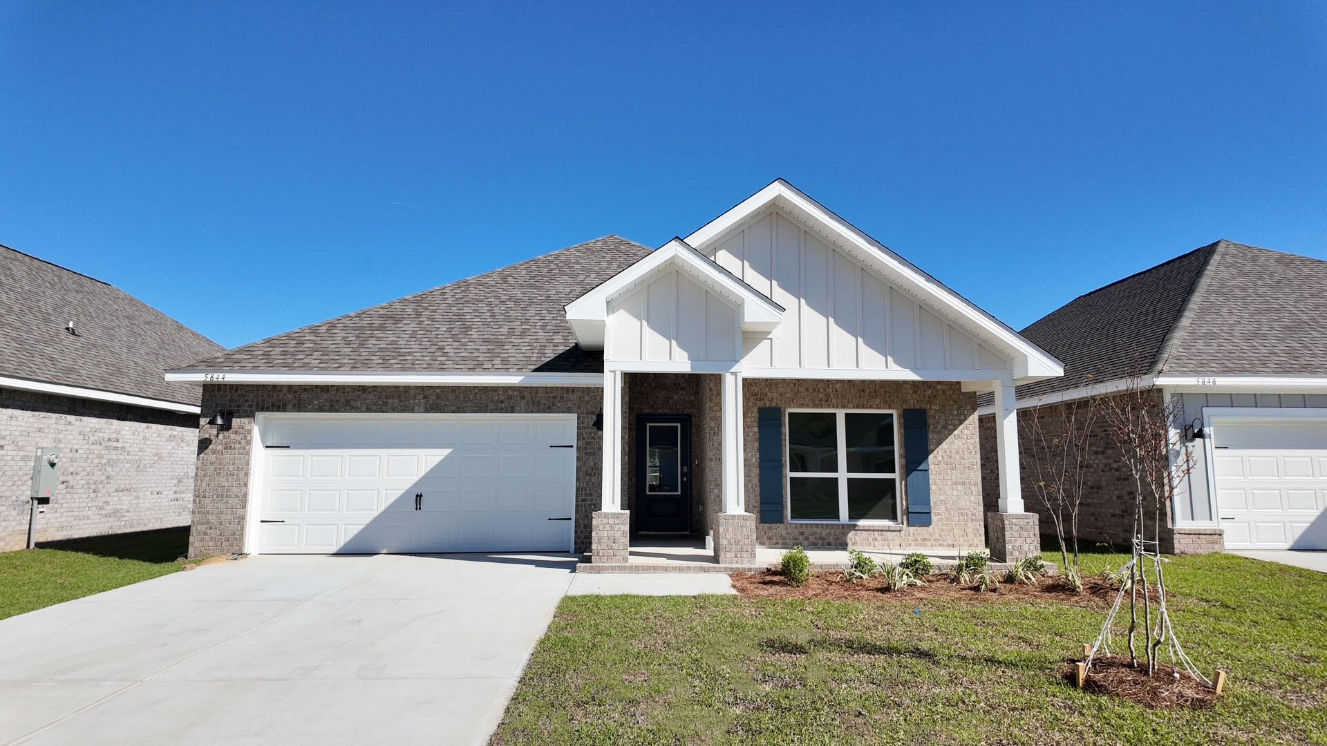 5844 Dove Nest Road Gulf Breeze, FL 32563 - Photo 1 of 32 a front view of a house with garden