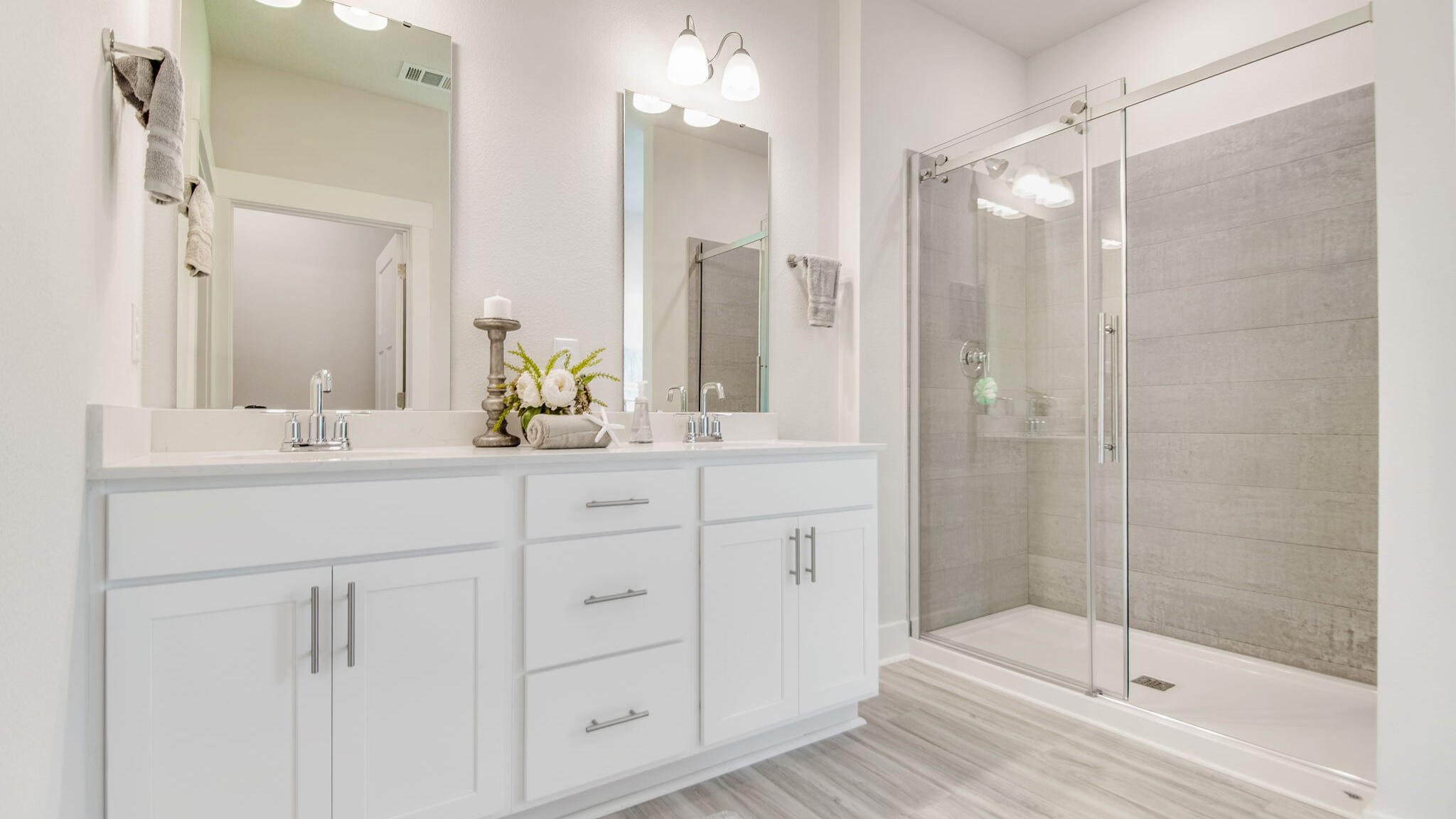 5844 Dove Nest Road Gulf Breeze, FL 32563 - Photo 18 of 32 a bathroom with a shower sink and mirror