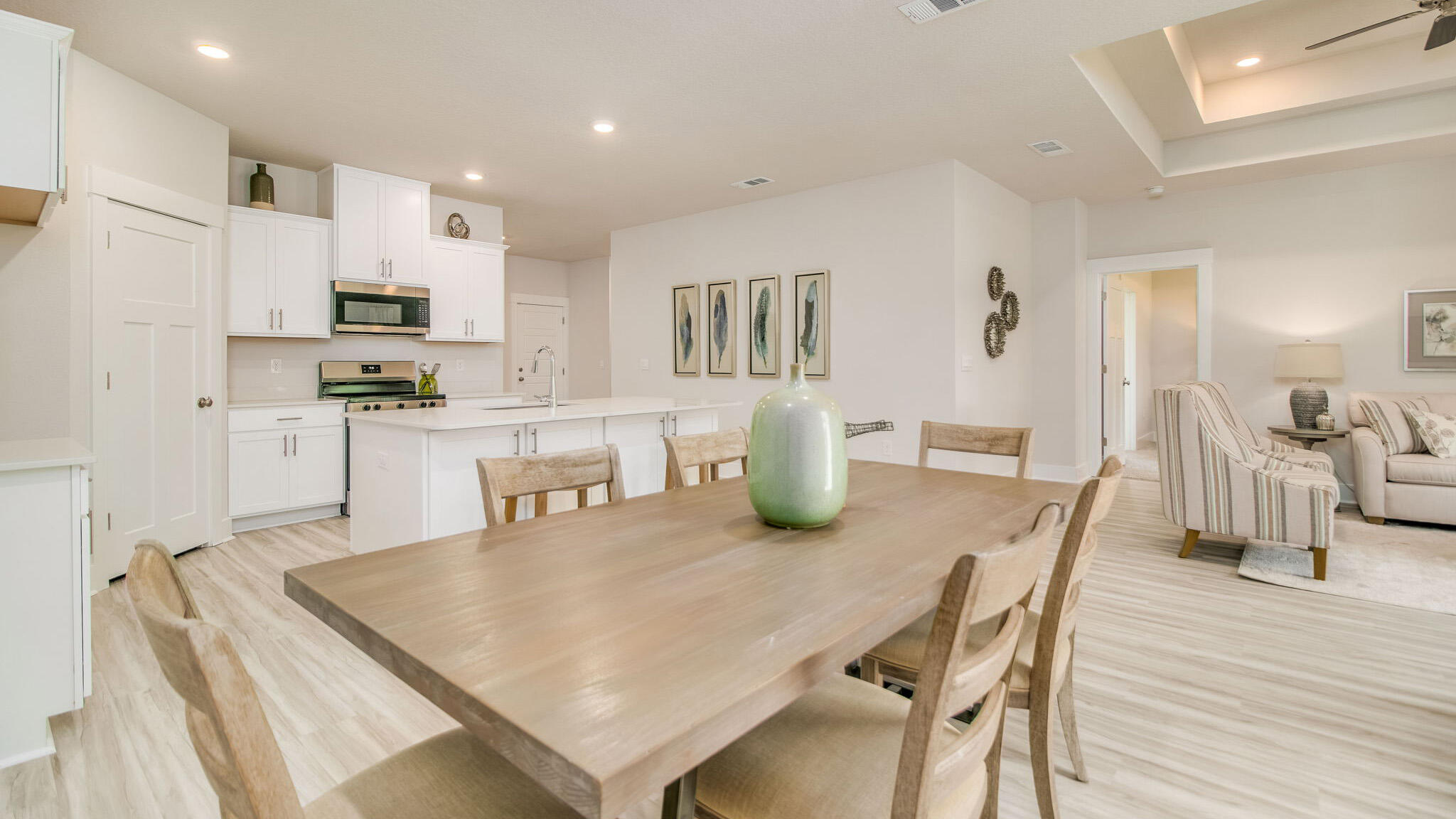 5844 Dove Nest Road Gulf Breeze, FL 32563 - Photo 7 of 32 a kitchen with stainless steel appliances granite countertop a dining table chairs and refrigerator