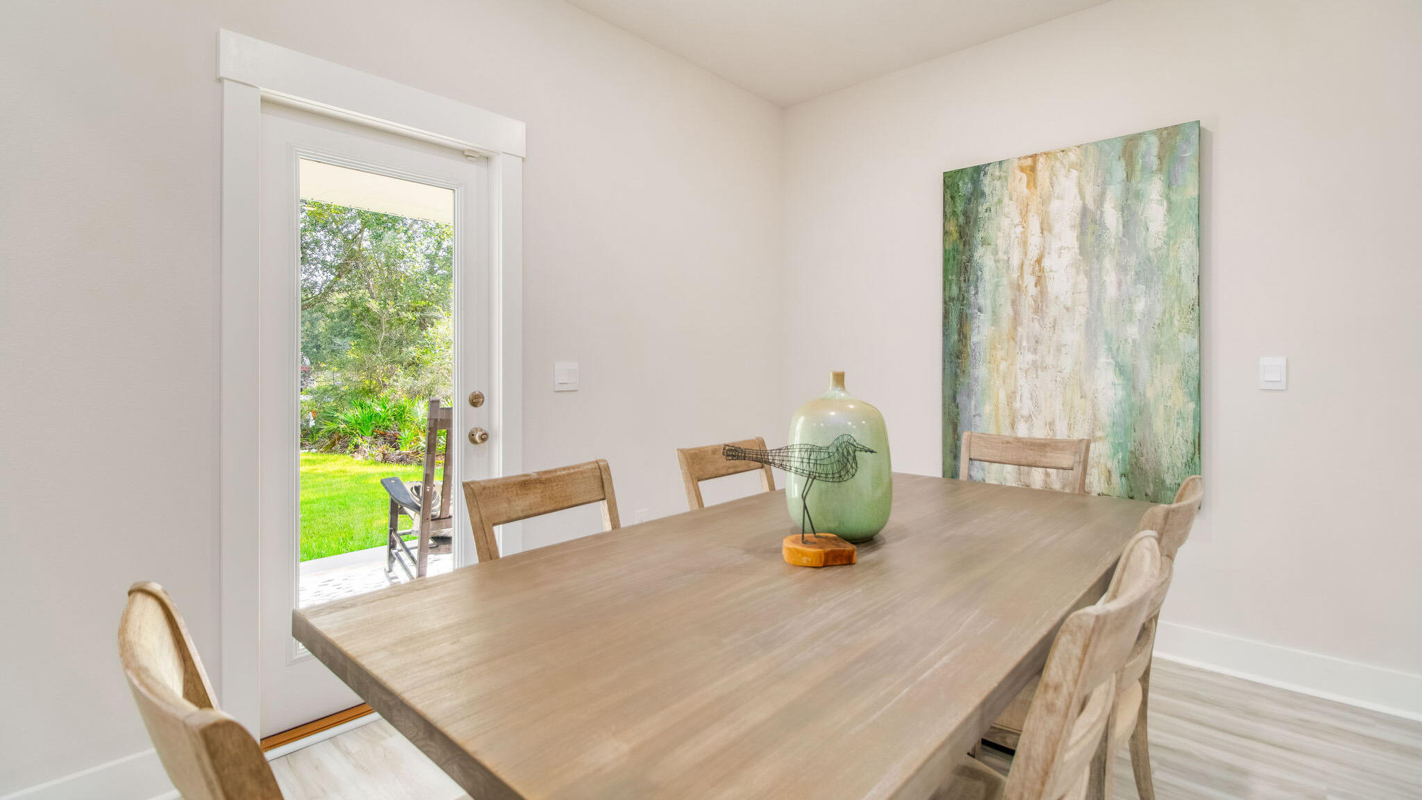 5844 Dove Nest Road Gulf Breeze, FL 32563 - Photo 9 of 32 a view of a dining room with a table and chairs