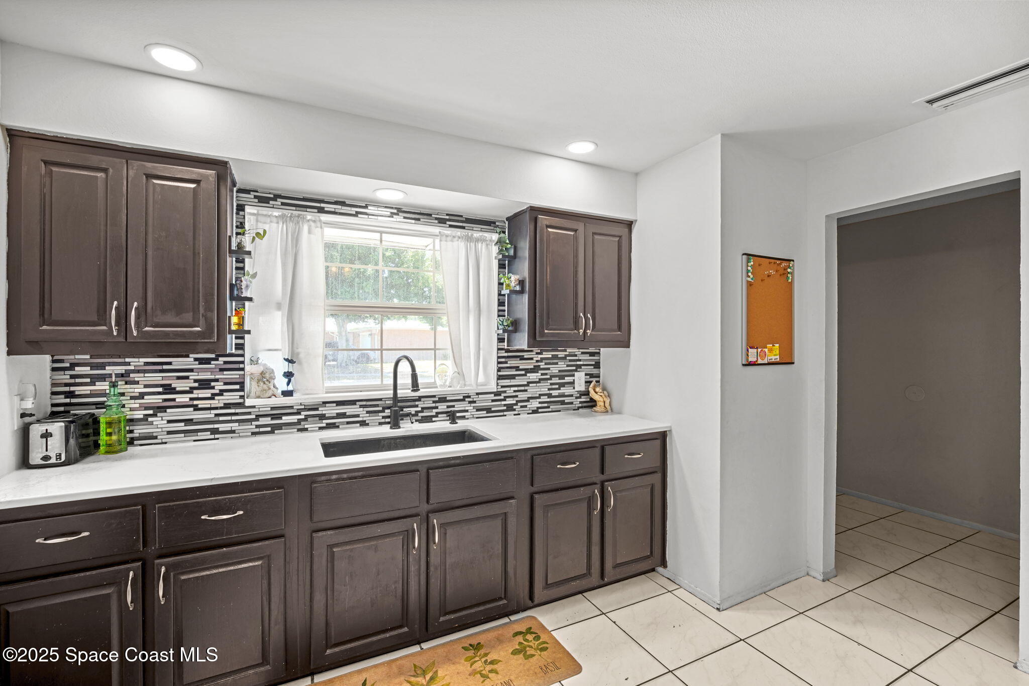 1044 Pompano Drive Rockledge, FL 32955 - Photo 12 of 28 a kitchen with a sink and cabinets