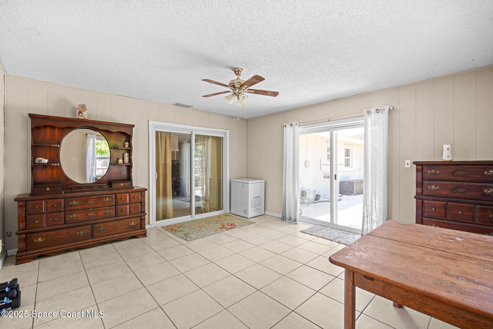 1044 Pompano Drive Rockledge, FL 32955 - Photo 14 of 28 a bedroom with a bed and a dresser