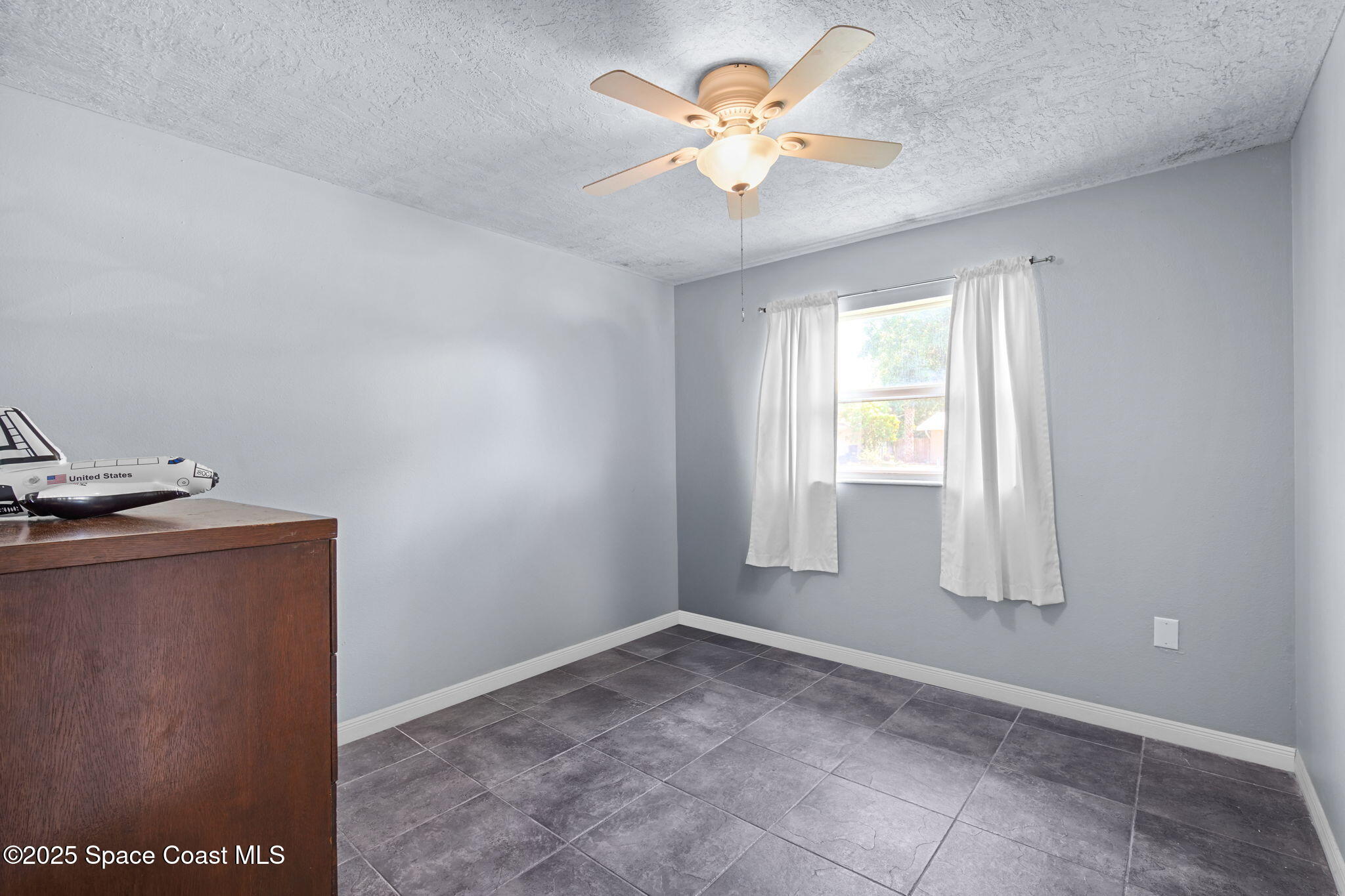 1044 Pompano Drive Rockledge, FL 32955 - Photo 15 of 28 an empty room with a window