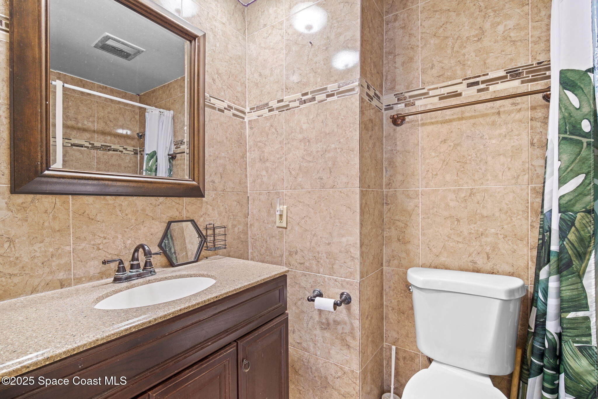 1044 Pompano Drive Rockledge, FL 32955 - Photo 17 of 28 a bathroom with a sink toilet and shower