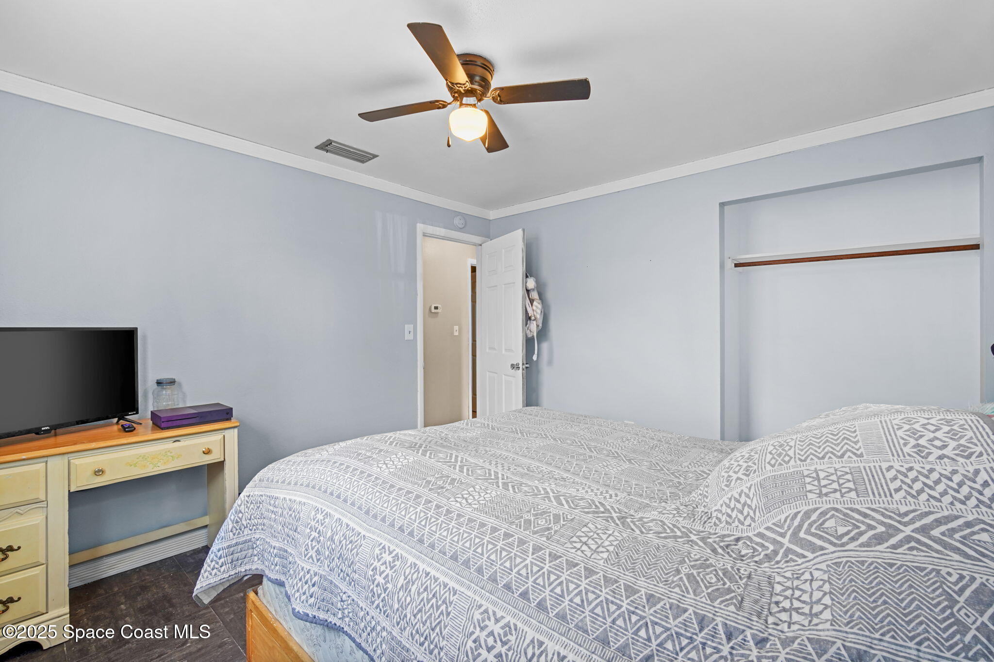 1044 Pompano Drive Rockledge, FL 32955 - Photo 20 of 28 a bedroom with a bed and a flat screen tv